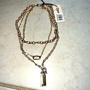 Triple strand gold plated necklace with “J” initial.